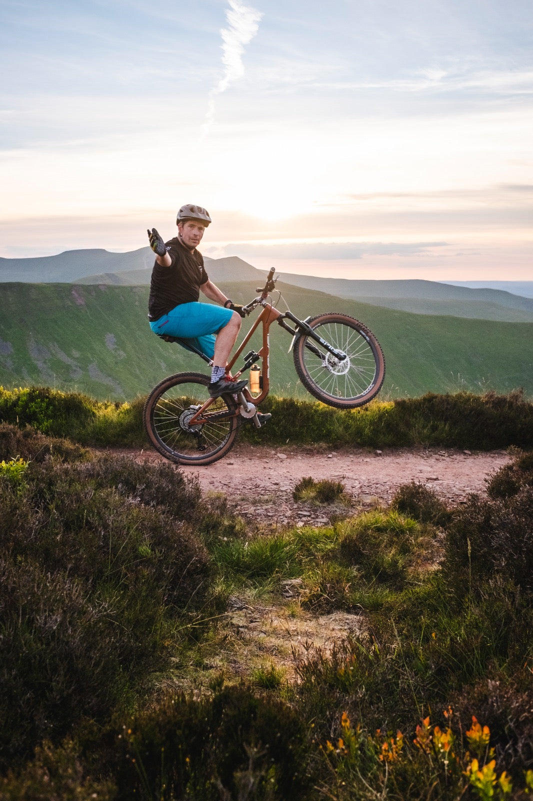 One handed wheelie riding a mountain bike